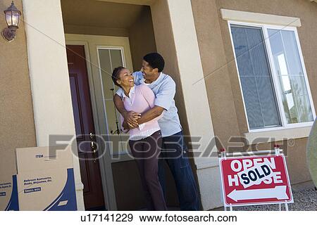 Couple moving into new house View Large Photo Image Stock Photo - Couple moving into new house. Fotosearch