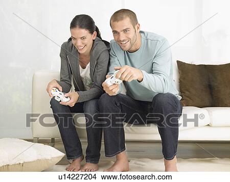Couple on Sofa Playing Video Game View Large Photo Image Picture - Couple on Sofa Playing Video Game. Fotosearch