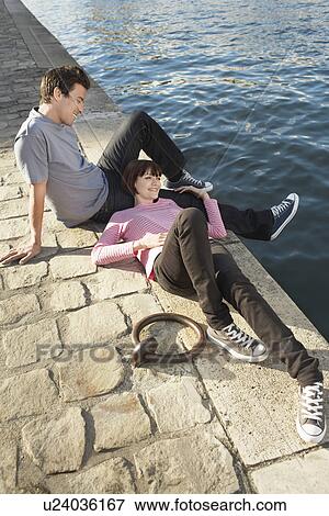Couple Relaxing by canal View Large Photo Image Stock Photo - Couple Relaxing by canal. Fotosearch