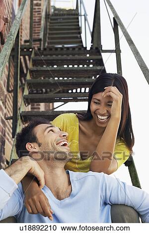 Couple sitting on fire escape stairs View Large Photo Image Stock Image - Couple sitting on fire escape stairs. Fotosearch