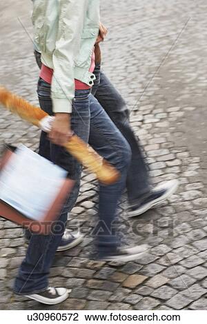Couple walking, carrying baguette and bags, low section View Large Photo Image Stock Image - Couple walking, carrying baguette and bags, low section. Fotosearch
