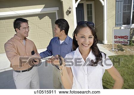 Couple with keys to new home View Large Photo Image Stock Image - Couple with keys to new home. Fotosearch