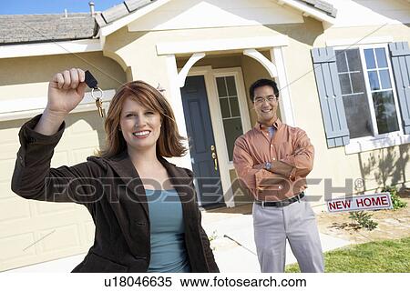 Couple with keys to new home View Large Photo Image Stock Photography - Couple with keys to new home. Fotosearch