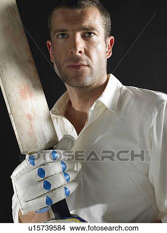 Cricket player holding cricket bat, portrait View Large Photo Image Picture - Cricket player holding cricket bat, portrait. Fotosearch