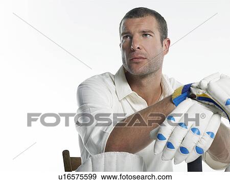 Stock Photo - Cricket player, sitting in chair, low angle view. Fotosearch