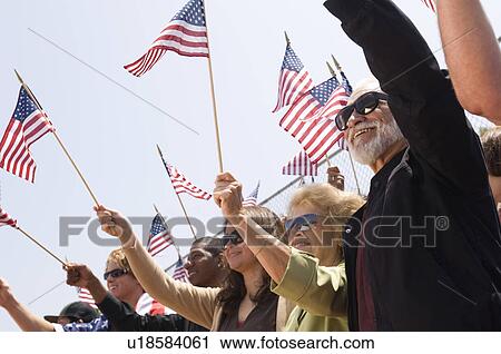 Stock Image - Crowd holding American flags. Fotosearch