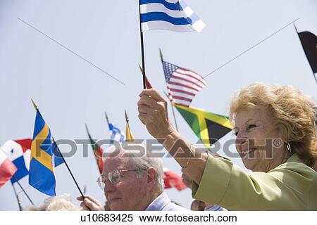Crowd holding up National flags View Large Photo Image Stock Photography - Crowd holding up National flags. Fotosearch