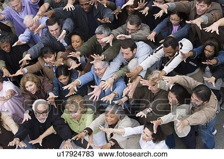 Stock Image - Crowd with arms raised. Fotosearch