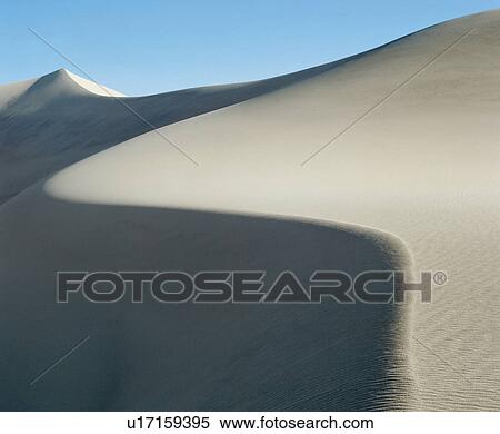 Stock Photography - Curved ridge of sand dune. Fotosearch
