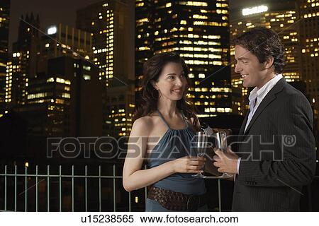 Elegant Couple on a Date, against nighttimes cityscape View Large Photo Image Stock Photography - Elegant Couple on a Date, against nighttimes cityscape. Fotosearch