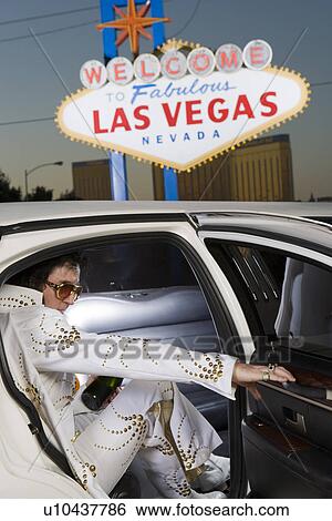 Stock Photograph - Elvis impersonator in limo in Las Vegas, Nevada, USA. Fotosearch