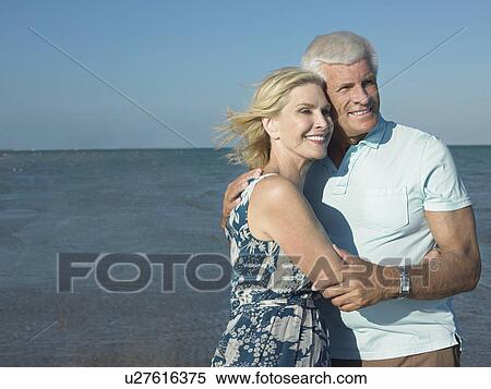Embraced senior couple on beach View Large Photo Image Stock Photography - Embraced senior couple on beach. Fotosearch