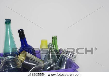 Picture - Empty bottles and cans in container, close-up. Fotosearch
