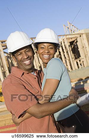 Enthusiastic couple in construction site View Large Photo Image Stock Photography - Enthusiastic couple in construction site. Fotosearch