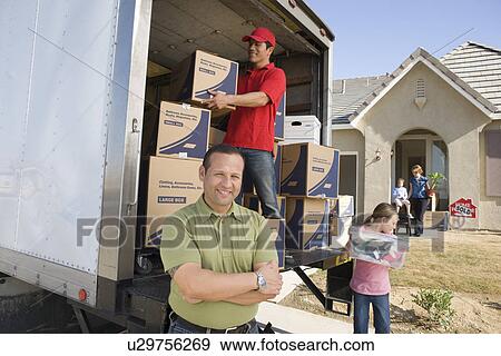 Family and worker unloading truck of cardboard boxes View Large Photo Image Stock Photo - Family and worker unloading truck of cardboard boxes. Fotosearch