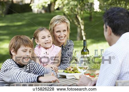 Family of four having picnic in park together, portrait View Large Photo Image Stock Photo - Family of four having picnic in park together, portrait. Fotosearch