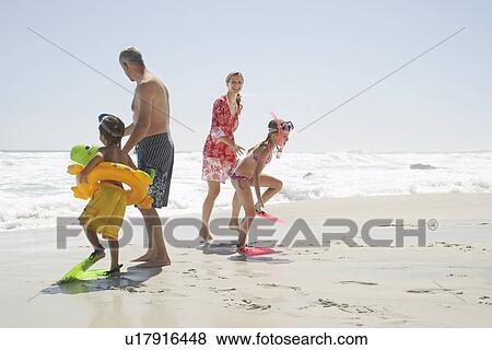 Stock Photo - Family Playing on Beach. Fotosearch