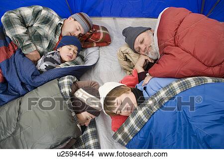 Picture - Family sleeping in tent. Fotosearch