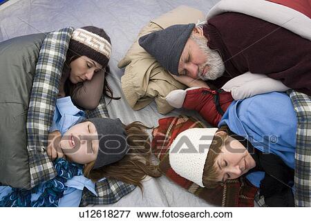 Stock Photo - Family sleeping in tent. Fotosearch