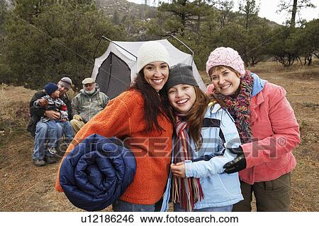 Family with children (7-12) camping, (portrait) View Large Photo Image Stock Photograph - Family with children (7-12) camping, (portrait). Fotosearch