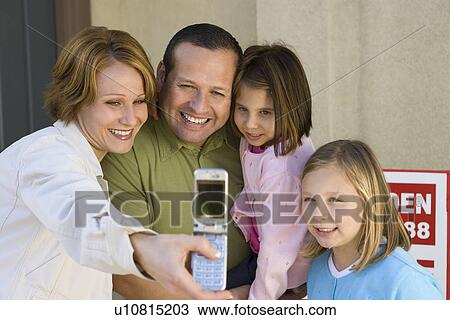 Family with two children (6-9) photographing with mobile View Large Photo Image Stock Image - Family with two children (6-9) photographing with mobile. Fotosearch