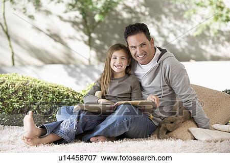 Father and daughter reading on floor, portrait View Large Photo Image Stock Photo - Father and daughter reading on floor, portrait. Fotosearch