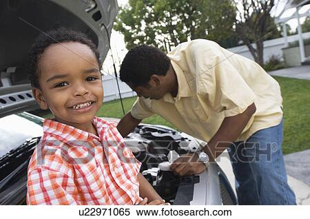 Father and son (5-6) repairing car's engine View Large Photo Image Stock Photography - Father and son (5-6) repairing car's engine. Fotosearch