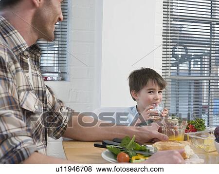 Stock Photo - Father and Son at Dinner Table. Fotosearch