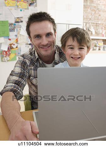 Picture - Father and Son at Laptop. Fotosearch