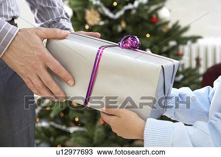 Father and Son Exchanging Gifts, close up of hands View Large Photo Image Stock Image - Father and Son Exchanging Gifts, close up of hands. Fotosearch