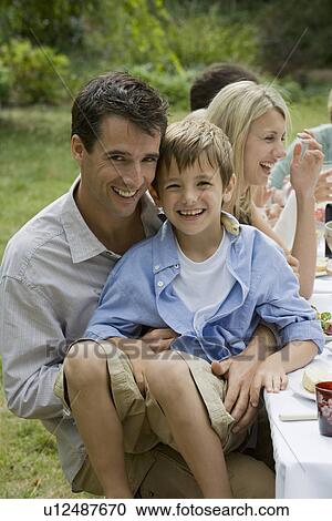 Father Holding Son at Family Picnic View Large Photo Image Stock Image - Father Holding Son at Family Picnic. Fotosearch