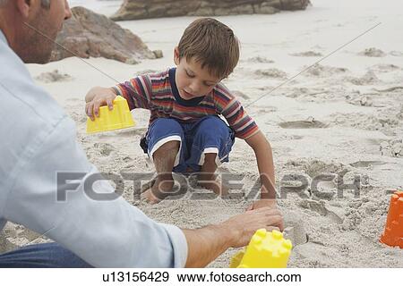 Stock Photo - Father Playing with Son on Beach. Fotosearch