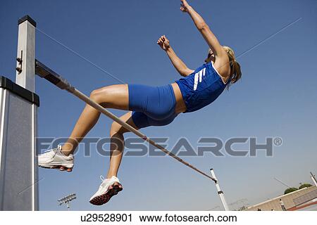 Female athlete high-jumping, low angle view View Large Photo Image Stock Image - Female athlete high-jumping, low angle view. Fotosearch