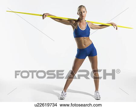 Female athlete holding javelin behind shoulders View Large Photo Image Picture - Female athlete holding javelin behind shoulders. Fotosearch