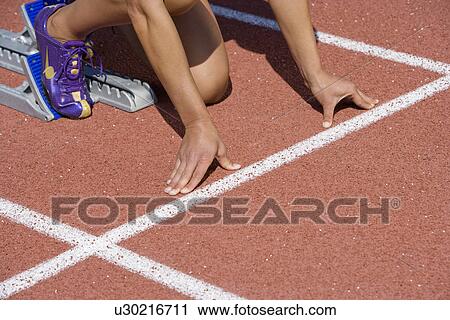 Female athlete in starting block, ready to run View Large Photo Image Stock Image - Female athlete in starting block, ready to run. Fotosearch