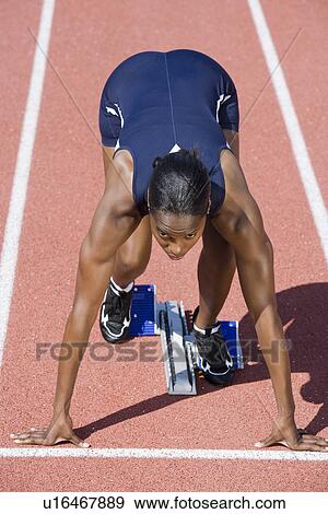 Female athlete in starting block, ready to run View Large Photo Image Stock Photo - Female athlete in starting block, ready to run. Fotosearch
