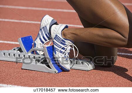 Female athlete in starting block, ready to run View Large Photo Image Stock Photo - Female athlete in starting block, ready to run. Fotosearch