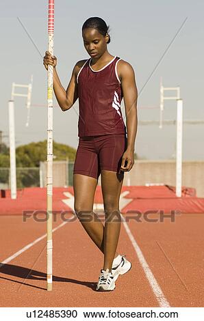 Female athlete preparing for pole jump View Large Photo Image Stock Image - Female athlete preparing for pole jump. Fotosearch