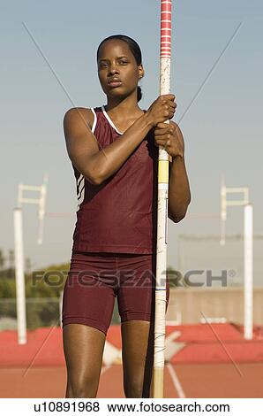 Stock Photo - Female athlete preparing for pole jump. Fotosearch