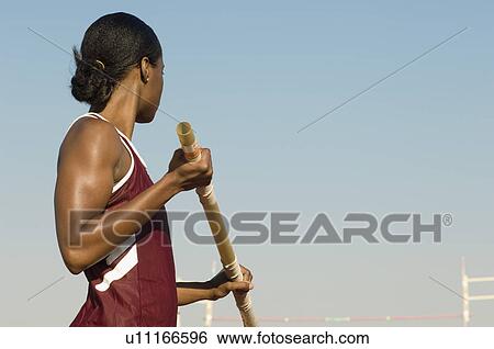 Female athlete preparing for pole jump View Large Photo Image Stock Photograph - Female athlete preparing for pole jump. Fotosearch