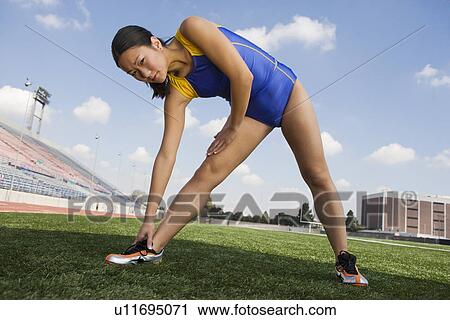 Female athlete stretching, portrait View Large Photo Image Stock Image - Female athlete stretching, portrait. Fotosearch