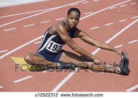 Female athlete stretching View Large Photo Image Stock Image - Female athlete stretching. Fotosearch