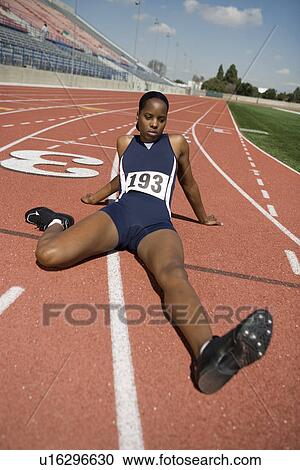 Stock Image - Female athlete stretching. Fotosearch