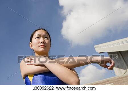 Female athlete stretching View Large Photo Image Stock Image - Female athlete stretching. Fotosearch