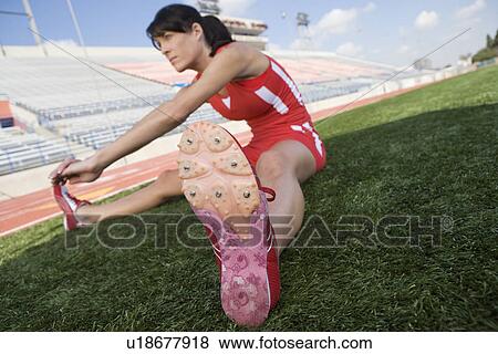 Female athlete stretching View Large Photo Image Stock Photo - Female athlete stretching. Fotosearch