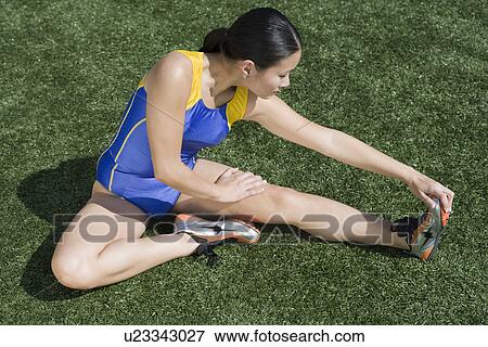 Stock Photo - Female athlete stretching. Fotosearch