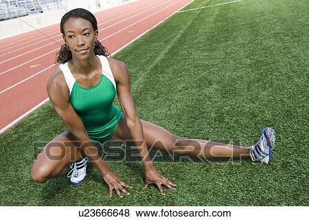 Stock Photo - Female athlete stretching. Fotosearch