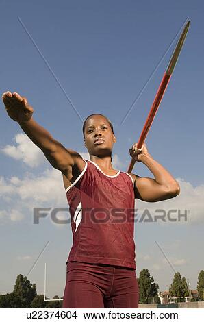 Picture - Female athlete throwing javelin. Fotosearch