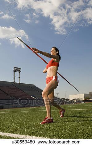 Female athlete throwing javelin View Large Photo Image Stock Image - Female athlete throwing javelin. Fotosearch