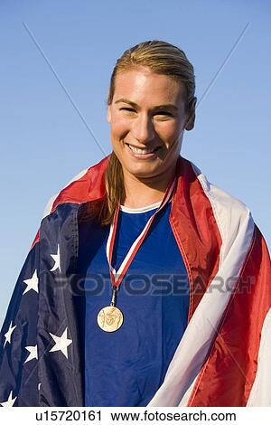 Female athlete wrapped in american flag with golden medal on neck View Large Photo Image Stock Image - Female athlete wrapped in american flag with golden medal on neck. Fotosearch